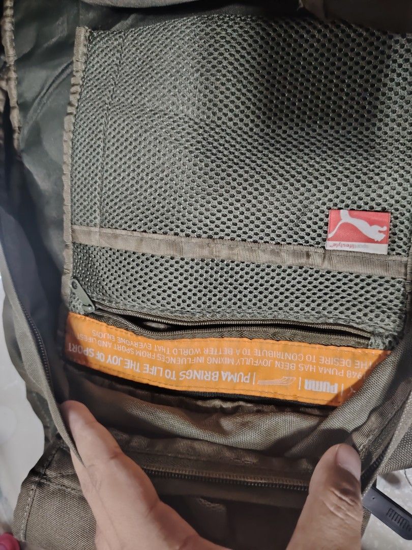 Puma Backpack (Category: Backpacks) located in Manila. Submitted by drxx.drip_19 (Listing ID 1425276003, Image 3). Description: Puma backpack features multiple compartments, including a mesh pocket and a main compartment with a zipper closure. It has adjustable straps and a top handle for carrying. The backpack is made in China and has the Puma logo on the front and straps. The dimensions are approximately 43cm in height and 30cm in width..