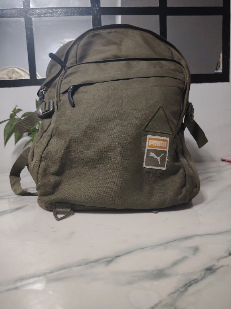 Puma Backpack (Category: Backpacks) located in Manila. Submitted by drxx.drip_19 (Listing ID 1425276003, Image 1). Description: Puma backpack features multiple compartments, including a mesh pocket and a main compartment with a zipper closure. It has adjustable straps and a top handle for carrying. The backpack is made in China and has the Puma logo on the front and straps. The dimensions are approximately 43cm in height and 30cm in width..