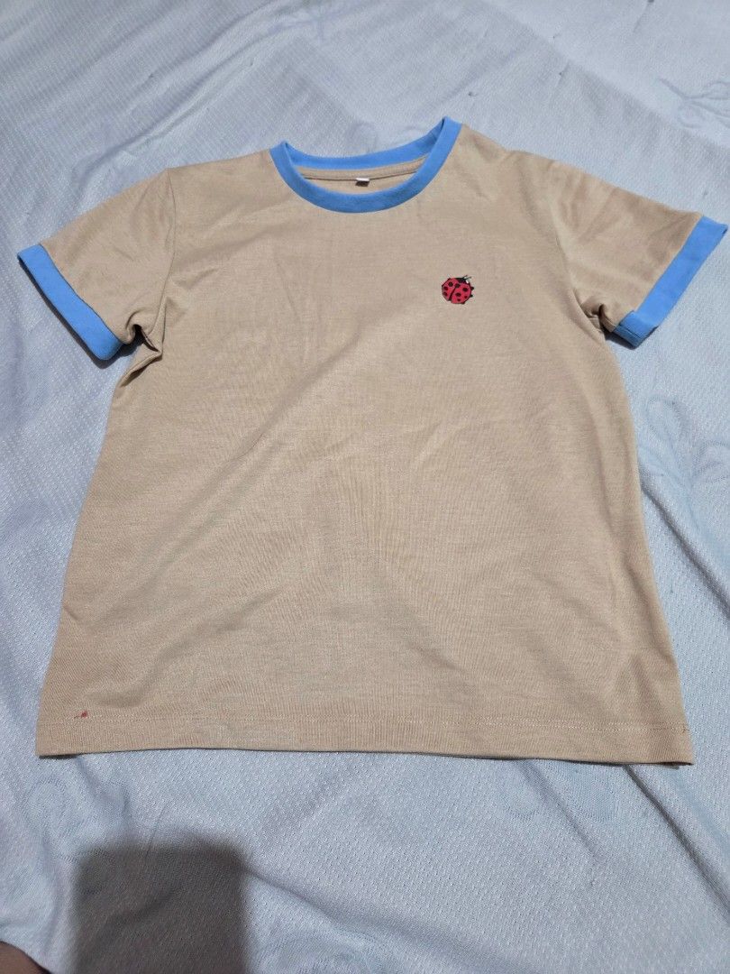 Ringer baby tee shirt with Ladybug (Category: Shirts) located in Manila. Submitted by declutterwtly (Listing ID 1425388428, Image 2). Description: Send me your offers, TYSM! ♡ -Beige t-shirt features a ladybug embroidery on the chest and blue trim on the collar and sleeves. -It has a round neck and short sleeves. -The t-shirt is a simple, versatile piece that can be paired with various bottoms..