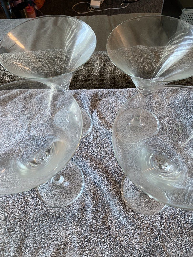 Set of Martini Glasses (Category: Dinnerware & Cutlery) located in Makati City. Submitted by rye16 (Listing ID 1425442254, Image 2). Description: Set of four martini glasses. These glasses have a classic triangular bowl design with a long stem and a round base. They are perfect for serving martinis or other cocktails. The glasses appear to be made of clear glass..