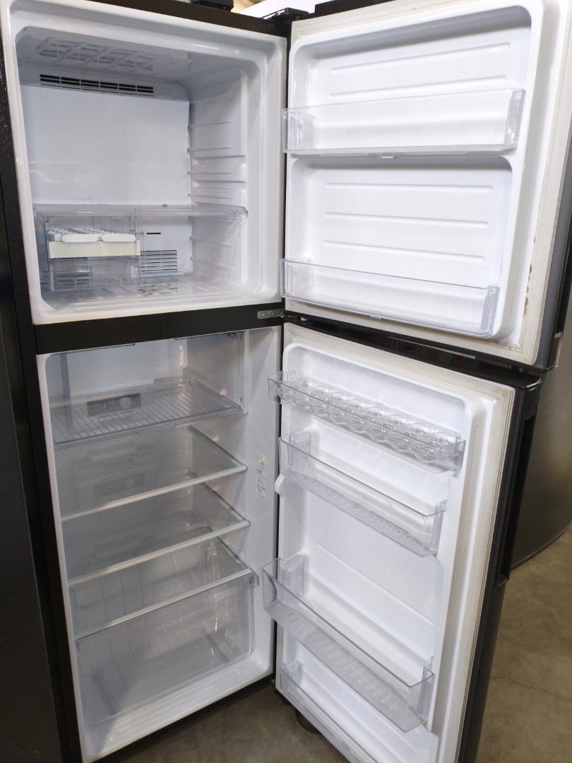 Sharp 7000D 13.3 cu. ft. Refrigerator Inverter (Category: Refrigerators and Freezers) located in Manila. Submitted by hmrgrace5. (Listing ID 1425251870, Image 2). Description: Sharp 7000D refrigerator with 13.3 cu. ft. capacity. Features an inverter for energy efficiency. The refrigerator has a top-freezer design with multiple shelves and door compartments for organized storage. The exterior is dark gray..