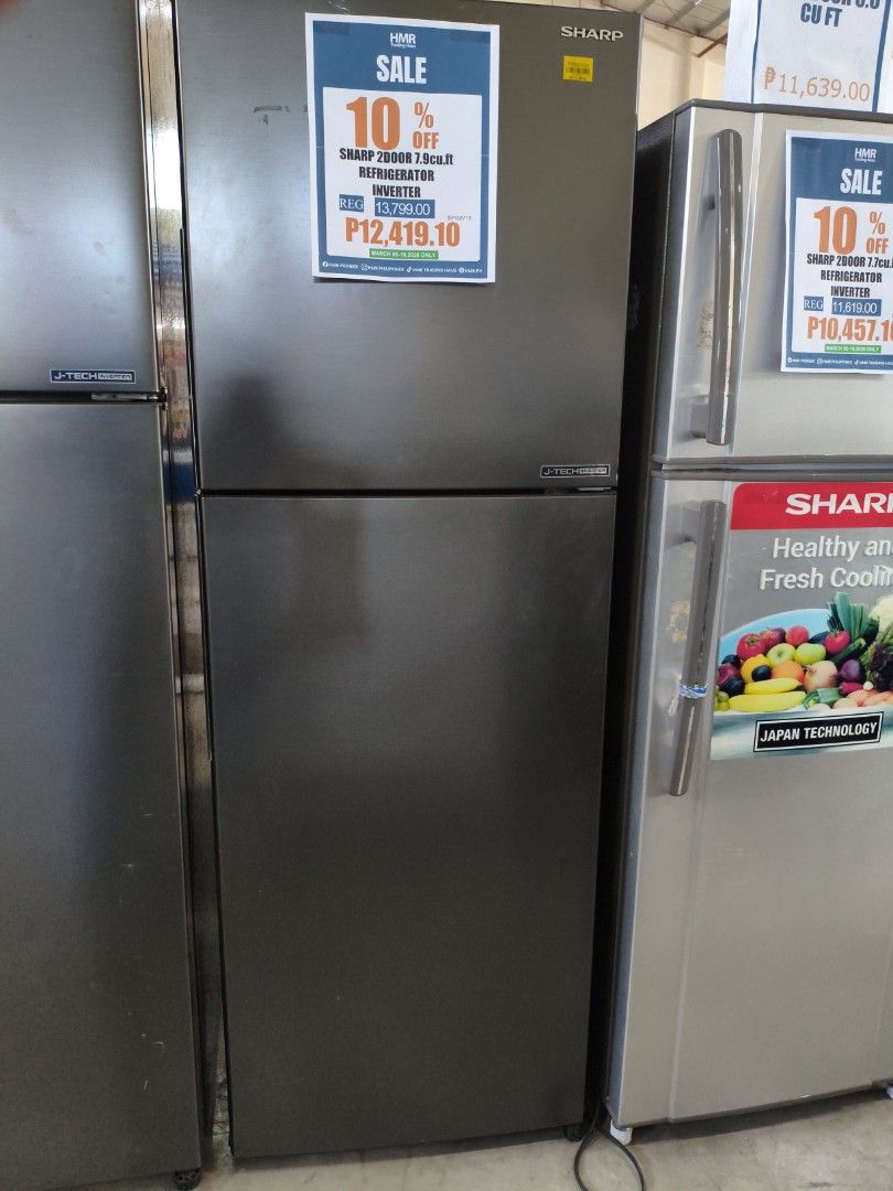 Sharp 7000D 13.3 cu. ft. Refrigerator Inverter (Category: Refrigerators and Freezers) located in Manila. Submitted by hmrgrace5. (Listing ID 1425251870, Image 1). Description: Sharp 7000D refrigerator with 13.3 cu. ft. capacity. Features an inverter for energy efficiency. The refrigerator has a top-freezer design with multiple shelves and door compartments for organized storage. The exterior is dark gray..