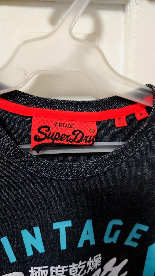 Superdry T-shirt (Category: Tshirts & Polo Shirts ) located in Paranaque City. Submitted by InsideDaBox (Listing ID 1425348002, Image 3). Description: 🚩Superdry Shirt ✅Pre-loved ✅Condition: 9/10 ✅Size: Medium ✅Color may vary due to lighting condition ✅May have crack prints ✅Location: Malasiqui, Pangasinan ✅Shipping thru J&T or LBC (Buyer's expense).