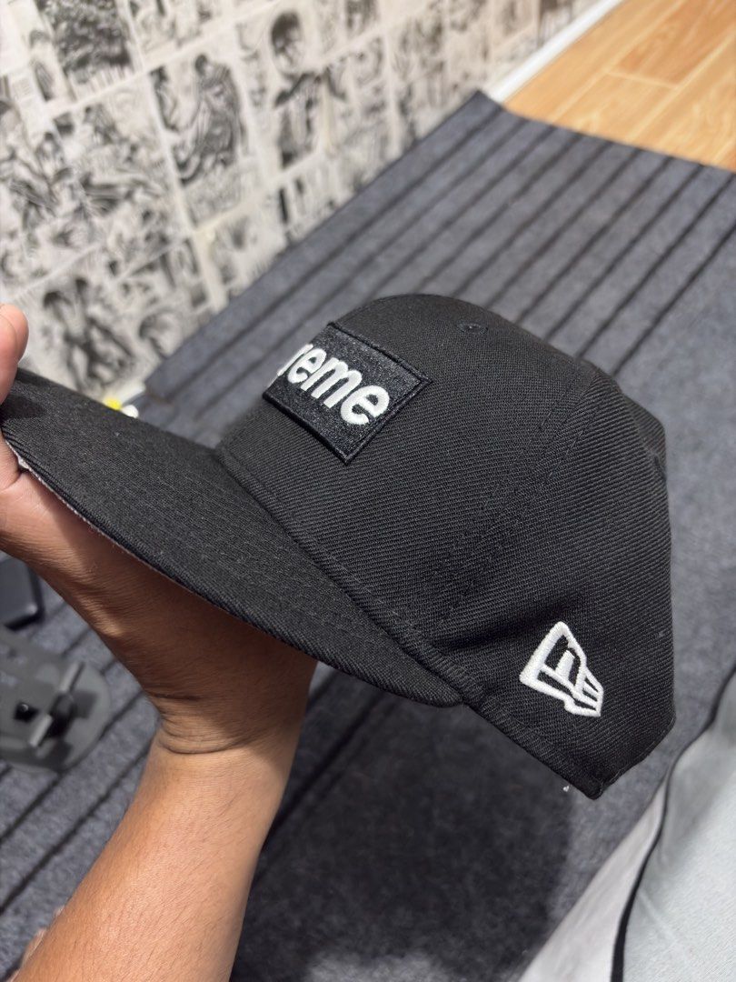 Supreme New Era 59Fifty Cap World Famous Authentic (Category: Caps & Hats) located in Caloocan City. Submitted by thrift4way (Listing ID 1425407966, Image 3). Description: Authentic Black Supreme Box Logo cap with a flat brim. Features the Supreme logo on the front and "World Famous 1994" on the side. The New Era logo is visible on the side. The cap is a 59Fifty model, size 7 1/4 (57.7cm). The tag indicates it was made in Japan..