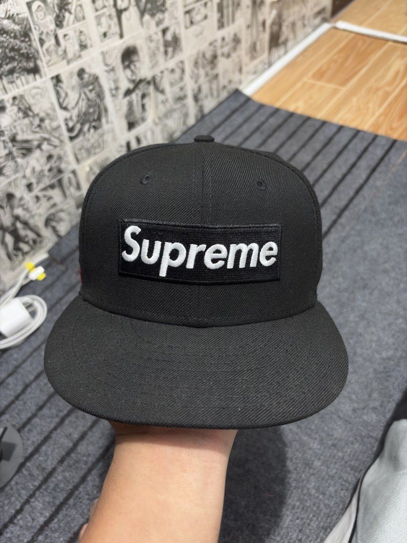 Supreme New Era 59Fifty Cap World Famous Authentic (Category: Caps & Hats) located in Caloocan City. Submitted by thrift4way (Listing ID 1425407966, Image 1). Description: Authentic Black Supreme Box Logo cap with a flat brim. Features the Supreme logo on the front and "World Famous 1994" on the side. The New Era logo is visible on the side. The cap is a 59Fifty model, size 7 1/4 (57.7cm). The tag indicates it was made in Japan..