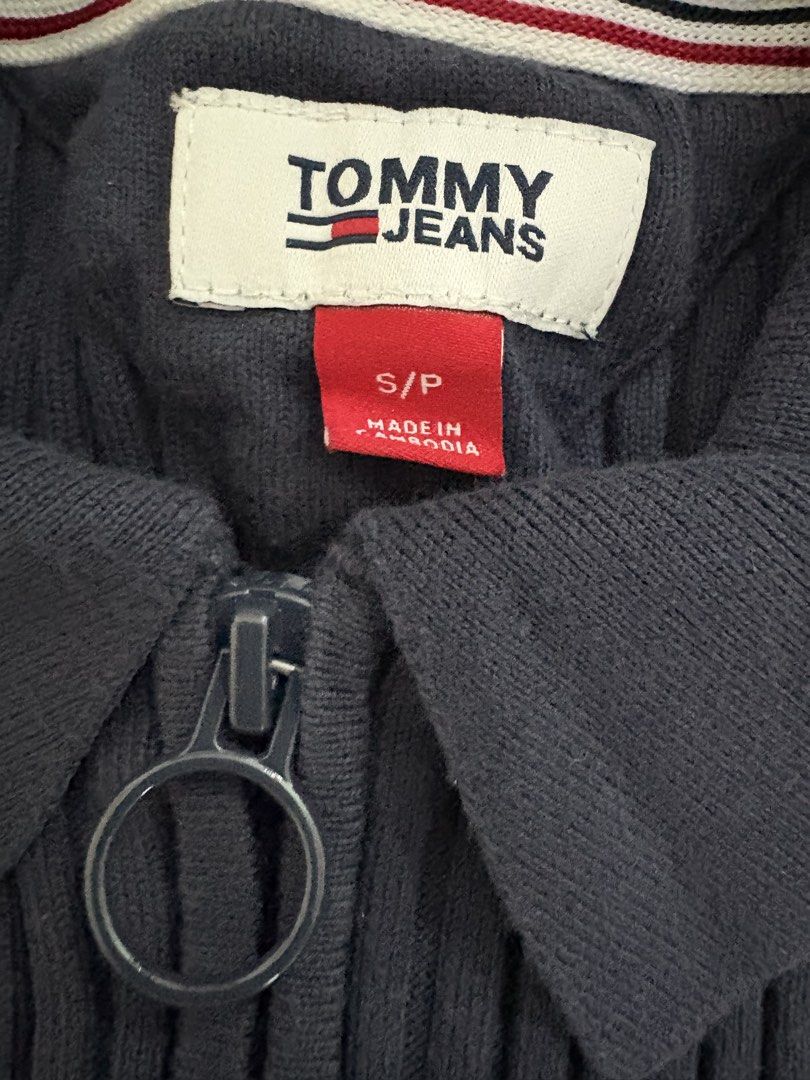 Tommy Jeans Ribbed Zip-Up Sweater (Category: Coats, Jackets and Outerwear) located in Manila. Submitted by rarity88 (Listing ID 1425341650, Image 2). Description: Like new Tommy Jeans navy blue sweater features a ribbed design and a zip-up closure. It has a small Tommy Jeans logo patch on the chest. Used only once. Fabric is stretchable. Tag says size S but best fits XS. Made from 80% cotton and 20% nylon. Please note that this needs to be washed