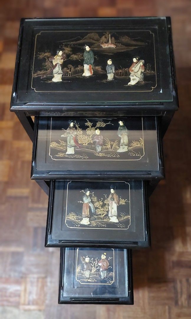 Vintage Chinese Nesting Tables (Category: Tables & Sets) located in Makati City. Submitted by geesharma_08 (Listing ID 1425338918, Image 1). Description: Rare and eye-catching mid-20th century decorative piece. This set of 4 ebonized nesting tables features inlaid mother-of-pearl and soapstone figural designs under glass tops. Hanpainted golden motifs are showcased around the edges. Previously used for display only (with minor signs of aging). Di