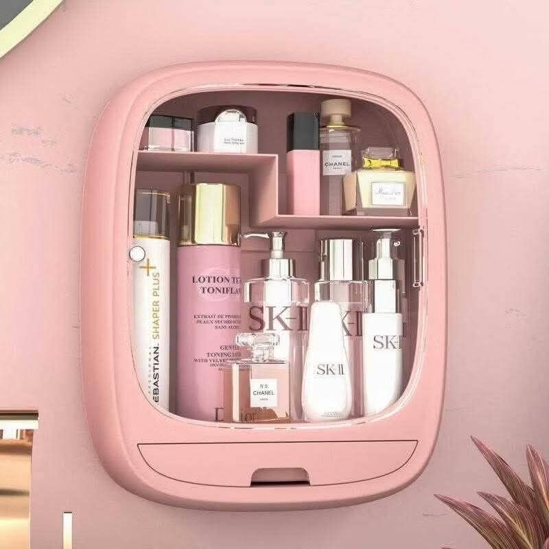 Wall-Mounted Cosmetic Organizer (Category: Makeup) located in Manila. Submitted by yzlshop (Listing ID 1425272948, Image 1). Description: Wall-mounted cosmetic organizer is perfect for storing your skincare and makeup essentials. It features multiple compartments and a small drawer for brushes or smaller items. Available in pink and blue. Dimensions are approximately 20cm height, 15.5cm width, and 11cm depth. The door is transparent, allowing you