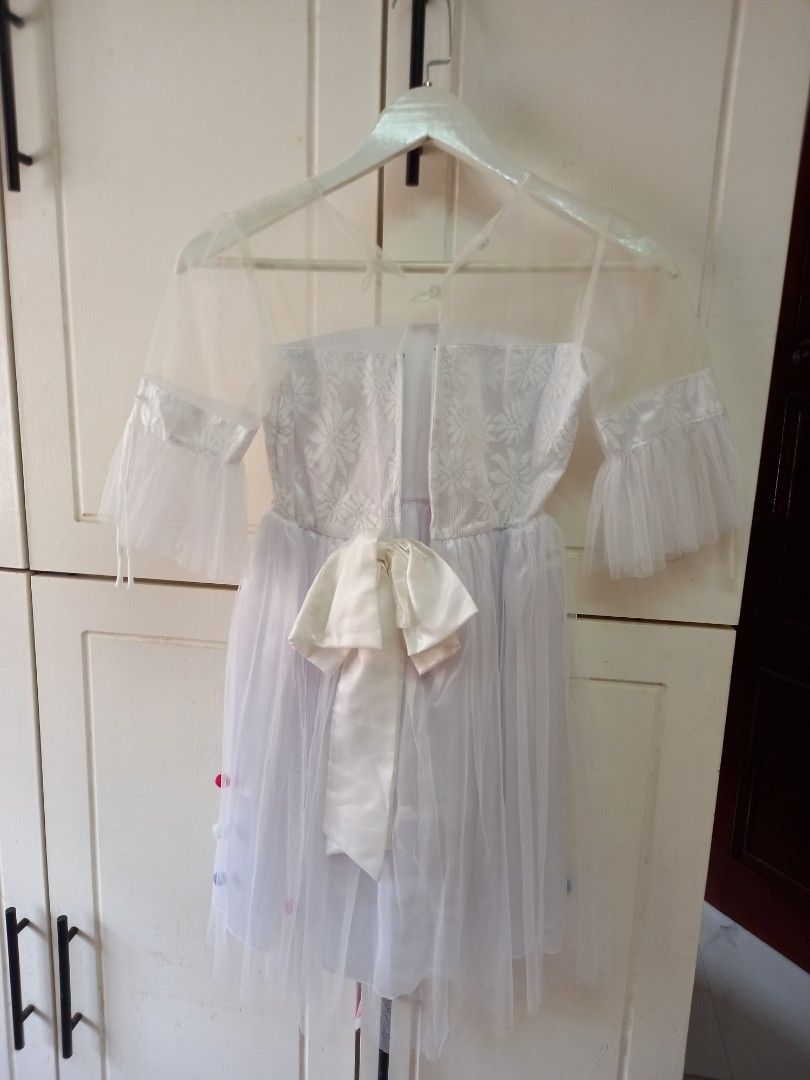 White Tulle Dress with Bow (Category: Dresses) located in Manila. Submitted by zenphoenix-7ad615 (Listing ID 1425296351, Image 3). Description: Beautiful white tulle dress features a sparkly bodice and delicate sleeves. The dress is adorned with colorful polka dots and a charming bow. Perfect for special occasions or a fun photoshoot. The dress is lightweight and airy, making it comfortable to wear. It is a lovely choice for any little girl..