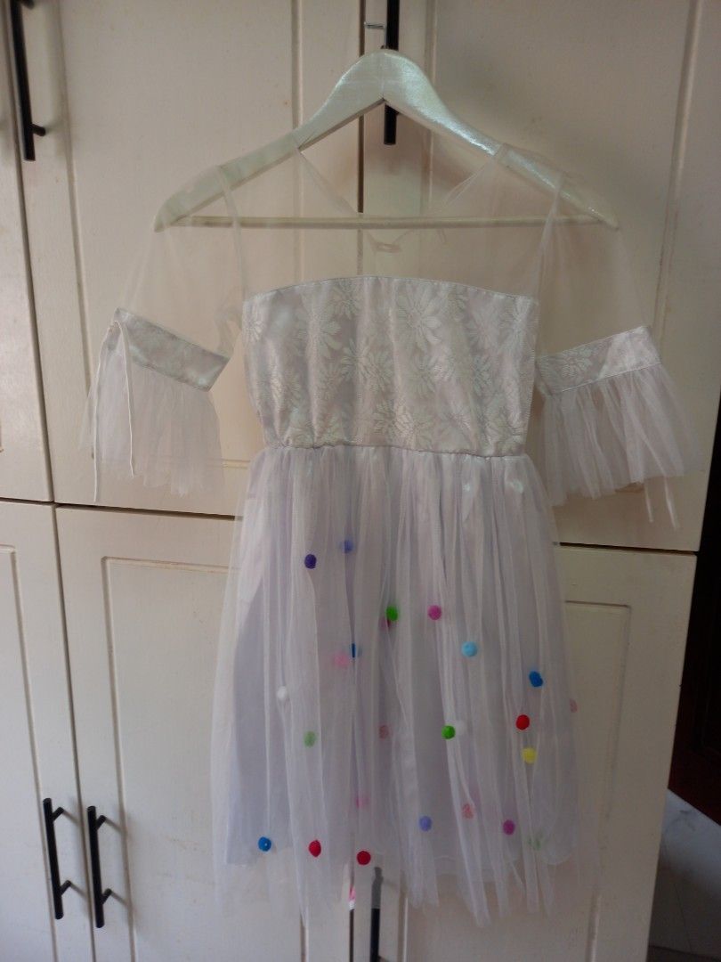 White Tulle Dress with Bow (Category: Dresses) located in Manila. Submitted by zenphoenix-7ad615 (Listing ID 1425296351, Image 1). Description: Beautiful white tulle dress features a sparkly bodice and delicate sleeves. The dress is adorned with colorful polka dots and a charming bow. Perfect for special occasions or a fun photoshoot. The dress is lightweight and airy, making it comfortable to wear. It is a lovely choice for any little girl..
