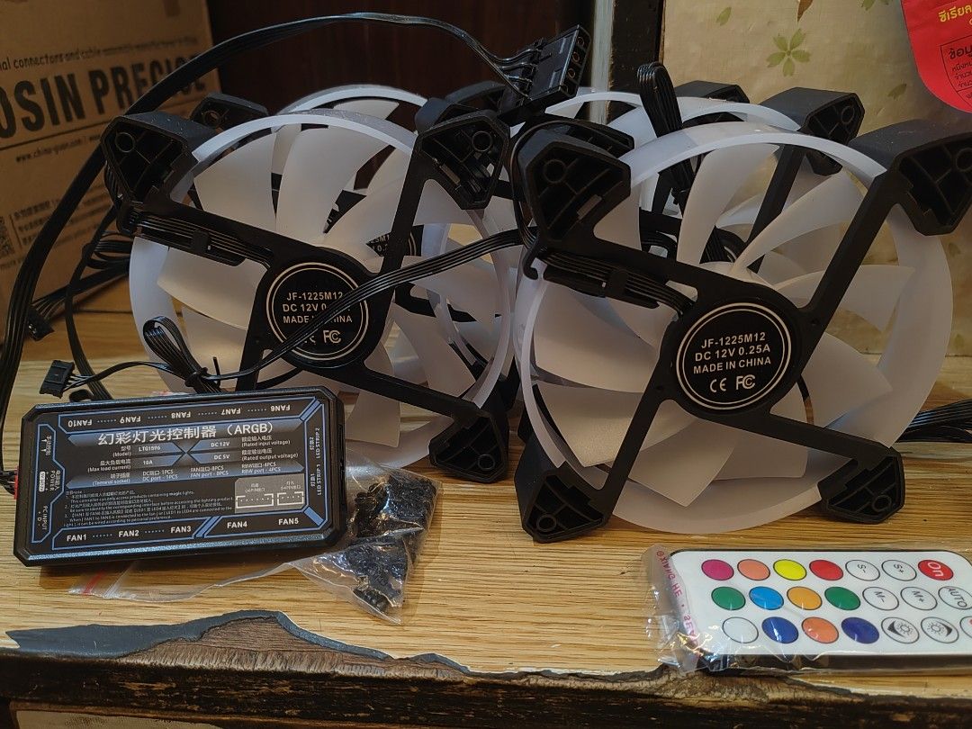 12cm RGB Cooling Fans Quiet Computer Case Chassis Fan Computer PC Cooler for PC Computer CPU 5pcs (Category: Computer Parts) located in Makati City. Submitted by jdcgarcia003381 (Listing ID 1425540671, Image 1). Description: Set of PC cooling fans with an included controller and remote. The fans are JF-1225M12 model, DC 12V 0.25A. Includes a controller with multiple fan ports and LED strip ports. The remote allows for color and mode control. Incl
