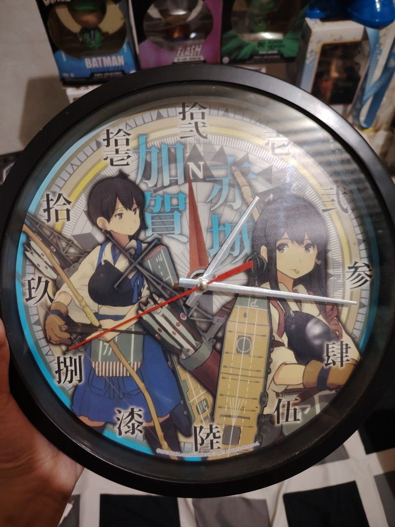Anime Wall Clock (Category: Clocks) located in Bulacan. Submitted by qilyuartstudio (Listing ID 1425580499, Image 1). Description: Anime-themed wall clock featuring two characters. The clock has a black frame and a white clock face with Japanese characters. The clock hands are red and white..