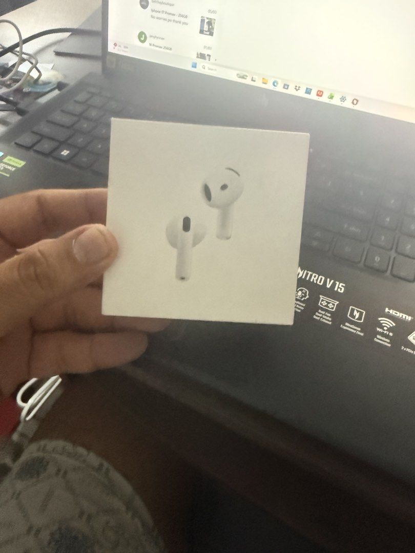 Apple AirPods 4 with Active Noise Cancellation (Category: Earphones) located in Taguig. Submitted by swiftpickz (Listing ID 1425575924, Image 2). Description: Apple AirPods 4 with Active Noise Cancellation. Includes the charging case. The box is included. The earphones are white. The charging case has a green light indicating it is charging. The box has text in multiple languages..