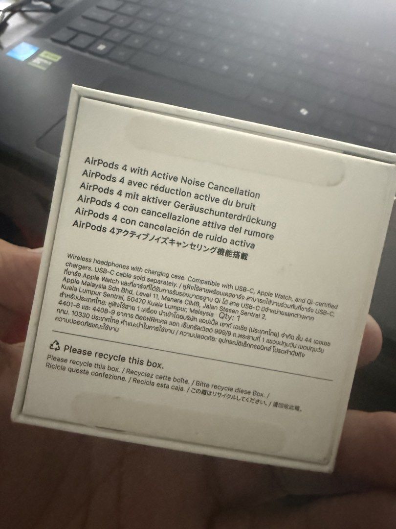Apple AirPods 4 with Active Noise Cancellation (Category: Earphones) located in Taguig. Submitted by swiftpickz (Listing ID 1425575924, Image 3). Description: Apple AirPods 4 with Active Noise Cancellation. Includes the charging case. The box is included. The earphones are white. The charging case has a green light indicating it is charging. The box has text in multiple languages..
