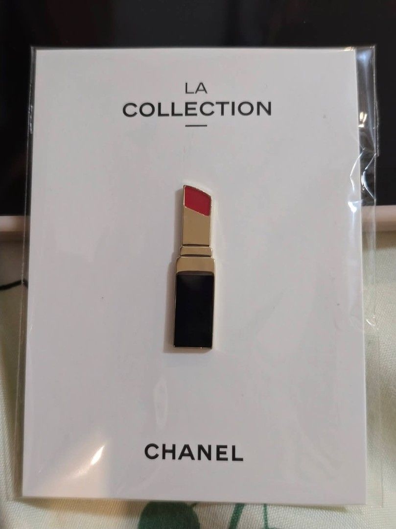 Authentic Chanel VIP "LA Collection" Lipstick Enamel Pin (Category: Other Accessories) located in Paranaque City. Submitted by bagznstuff (Listing ID 1425630443, Image 1). Description: A chic, limited-edition accessory from the Chanel Fragrance & Beauty VIP loyalty program. This enamel lapel pin is modeled after the iconic Rouge Allure lipstick. ​Design: Signature Chanel black and gold lipstick silhouette with vibrant red "lipstick" tip. ​Quality