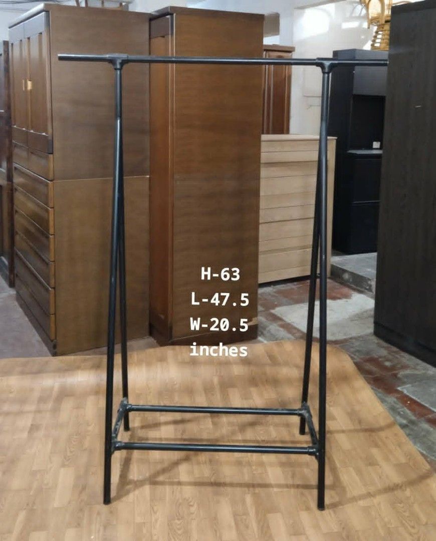 Black Metal Clothes Rack (Category: Clothes Drying Rack) located in Manila. Submitted by wiseocean.25b393 (Listing ID 1425512825, Image 1). Description: Sturdy black metal clothes rack. Dimensions: H-63 inches, L-47.5 inches, W-20.5 inches. Features a double bar design for hanging clothes. Suitable for organizing clothes in a bedroom or retail space. Simple and functional design..