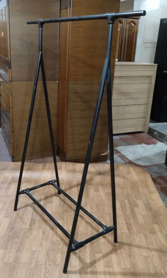 Black Metal Clothes Rack (Category: Clothes Drying Rack) located in Manila. Submitted by wiseocean.25b393 (Listing ID 1425512825, Image 2). Description: Sturdy black metal clothes rack. Dimensions: H-63 inches, L-47.5 inches, W-20.5 inches. Features a double bar design for hanging clothes. Suitable for organizing clothes in a bedroom or retail space. Simple and functional design..