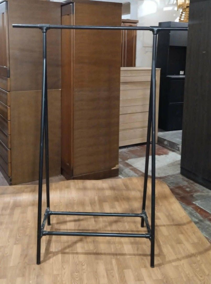 Black Metal Clothes Rack (Category: Clothes Drying Rack) located in Manila. Submitted by wiseocean.25b393 (Listing ID 1425512825, Image 3). Description: Sturdy black metal clothes rack. Dimensions: H-63 inches, L-47.5 inches, W-20.5 inches. Features a double bar design for hanging clothes. Suitable for organizing clothes in a bedroom or retail space. Simple and functional design..