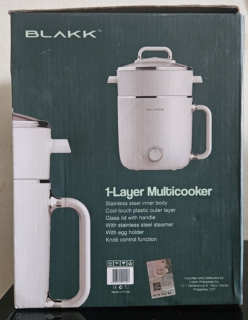 Blakk 1-Layer Multicooker (Category: Cookers) located in Manila. Submitted by allysa_trinkets (Listing ID 1425492819, Image 2). Description: Blakk 1-Layer Multicooker has a 1.8L capacity. It features a cool touch plastic outer layer, glass lid with handle, and stainless steel inner body. It also includes a stainless steel steamer and egg holder. The multicooker has a knob control function. It operates at 230V a.c., 60Hz, and 800W..
