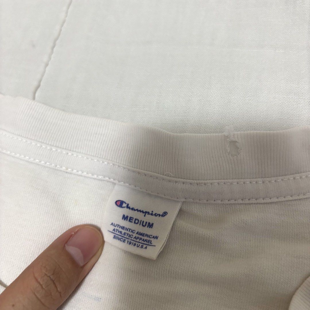 Champion White T-shirt Medium (Category: Shirts) located in Cabuyao City. Submitted by nesse21 (Listing ID 1425546863, Image 2). Description: Champion Tshirt Size: Medium Issue: Yellow Stains and Ink Rfs: Decluttering .