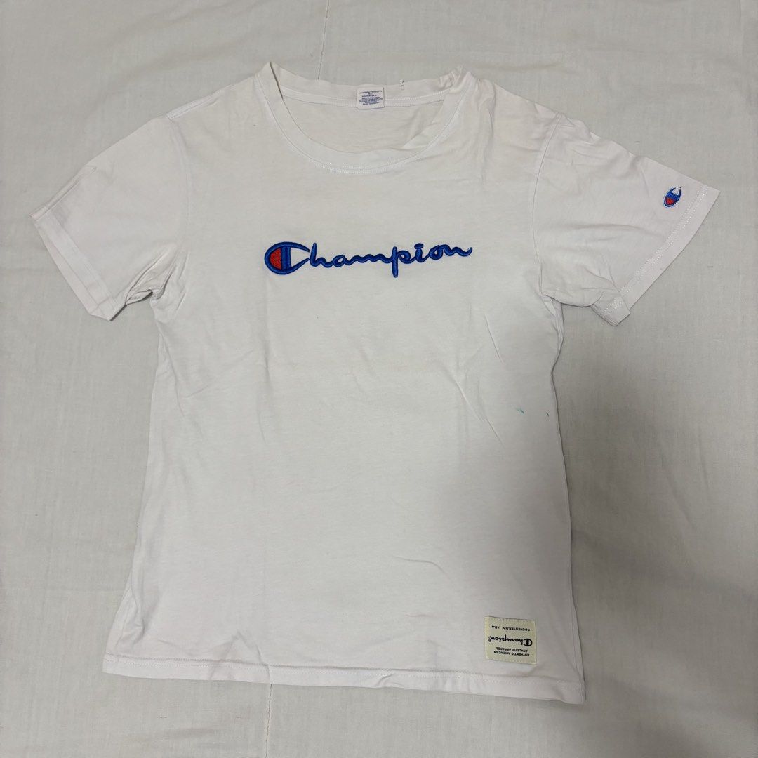 Champion White T-shirt Medium (Category: Shirts) located in Cabuyao City. Submitted by nesse21 (Listing ID 1425546863, Image 1). Description: Champion Tshirt Size: Medium Issue: Yellow Stains and Ink Rfs: Decluttering .