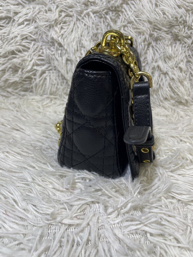 Christian Dior Black Shoulder Bag (Category: Luxury Bags & Wallets) located in Quezon City. Submitted by impulse.ph (Listing ID 1425625861, Image 3). Description: Black shoulder bag by Christian Dior. Features a quilted design with a gold-tone CD logo on the front. Includes a chain strap and a top handle. The interior has a zipper pocket and a Christian Dior label. Made in Italy. The bag has a serial number tag inside..