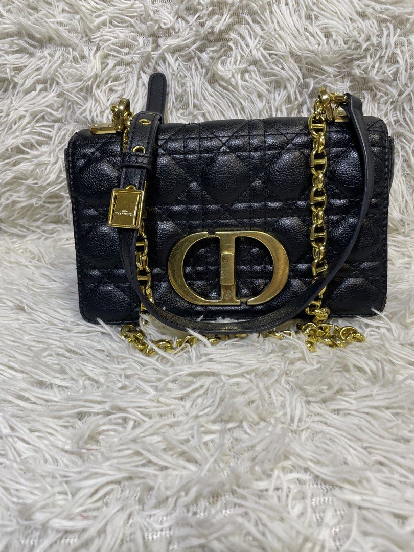 Christian Dior Black Shoulder Bag (Category: Luxury Bags & Wallets) located in Quezon City. Submitted by impulse.ph (Listing ID 1425625861, Image 1). Description: Black shoulder bag by Christian Dior. Features a quilted design with a gold-tone CD logo on the front. Includes a chain strap and a top handle. The interior has a zipper pocket and a Christian Dior label. Made in Italy. The bag has a serial number tag inside..