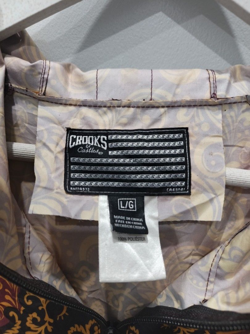 Crooks & Castles Floral Print Jacket (Category: Coats, Jackets and Outerwear) located in Leyte. Submitted by chaem89 (Listing ID 1425583330, Image 3). Description: Jacket features a vibrant floral print with a unique design. It has a full zipper closure and a hood. The jacket is a size L/G and is made of 100% polyester. The jacket has a distinctive pattern on the front and back. It is a stylish piece for everyday wear. -Excellent Cond -sz L on ta