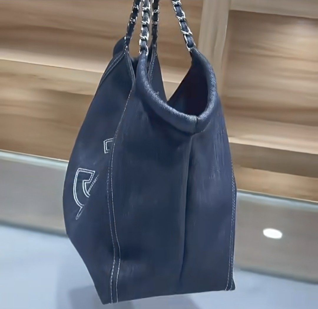 Denim Tote Bag (Category: Luxury Bags & Wallets) located in Makati City. Submitted by mccuachon (Listing ID 1425574272, Image 3). Description: Stylish Large Black Denim Tote Bag crafted from denim fabric. Features a chain strap and the iconic Ch@nel logo prominently displayed on the front. The bag has a spacious interior, perfect for everyday use. The stitching details add a touch of elegance to the design. A versatile accessory that complements 