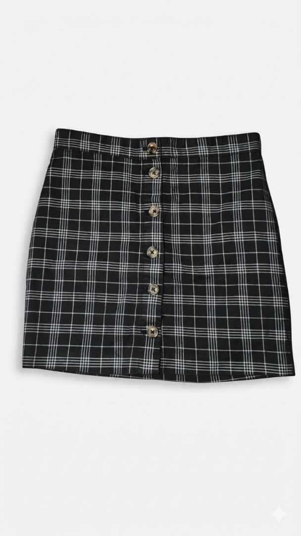 Divided Plaid Button-Up Skirt (Category: Skirts) located in Manila. Submitted by declutter_s (Listing ID 1425587226, Image 1). Description: Skirt features a classic plaid pattern with a button-up design. It has a mini length and a fitted silhouette. It has a black and white color scheme. The skirt has a button closure..