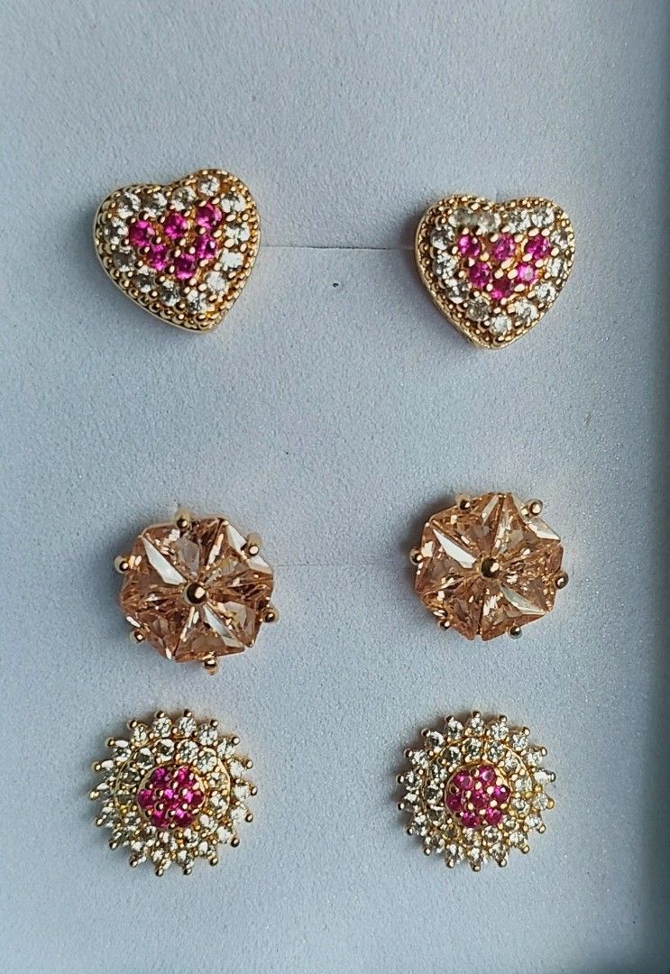 Gold Stud Earrings Set (Category: Earrings) located in Gapan. Submitted by purseofjune (Listing ID 1425482600, Image 1). Description: heart stud ruby and white stone P400 flower stud yellow stone P300 flower stud ruby P400 set for P800 in gold plated copper, ruby stone is uv reactive hypo allergenic long lasting plating with proper care.