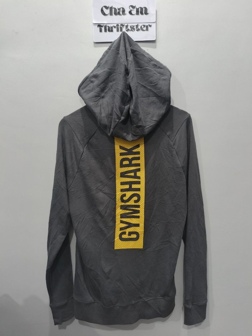 Gymshark Hoodie - Gray (Category: Hoodies) located in Leyte. Submitted by chaem89 (Listing ID 1425589998, Image 2). Description: Gray Gymshark hoodie. Features the Gymshark logo on the back. The size is S. Made in Madagascar. The material is 70% cotton, 30% recycled polyester for the hood lining, 95% polyester, and 5% elastane. -As new cond (no issue) Fresh from bale -sz S on tag 21x29.