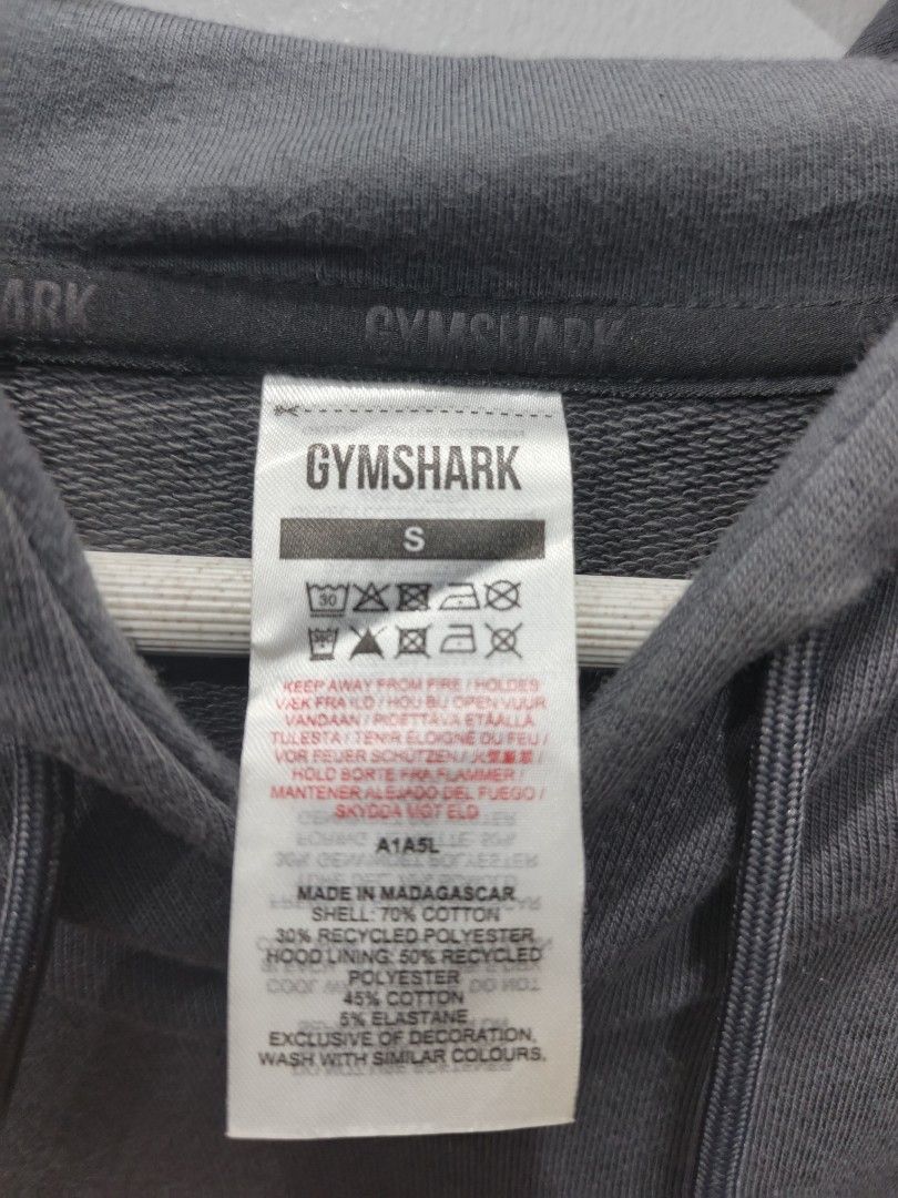 Gymshark Hoodie - Gray (Category: Hoodies) located in Leyte. Submitted by chaem89 (Listing ID 1425589998, Image 3). Description: Gray Gymshark hoodie. Features the Gymshark logo on the back. The size is S. Made in Madagascar. The material is 70% cotton, 30% recycled polyester for the hood lining, 95% polyester, and 5% elastane. -As new cond (no issue) Fresh from bale -sz S on tag 21x29.