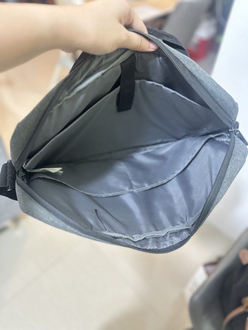 HP Laptop Bag - Gray (Category: Laptop Bags & Sleeves) located in General Trias. Submitted by keiperry_ (Listing ID 1425497569, Image 3). Description: Free pag bumili any from my item Atleast 1 HP laptop bag is gray with a blue zipper. It has a handle and a shoulder strap. The bag measures 42 cm in length and 30 cm in height. Inside, there are multiple compartments for organizing your belongings. It features the HP logo on the front..