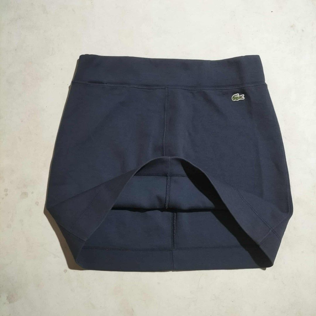 Lacoste Navy Blue Skirt Size 34 (Category: Skirts) located in Sindangan. Submitted by mix_thrift0308 (Listing ID 1425537073, Image 1). Description: Navy blue skirt from Lacoste. Features the iconic Lacoste logo on the front. The size tag indicates a size 34. Perfect for casual wear or light activities. The skirt has a simple, classic design..