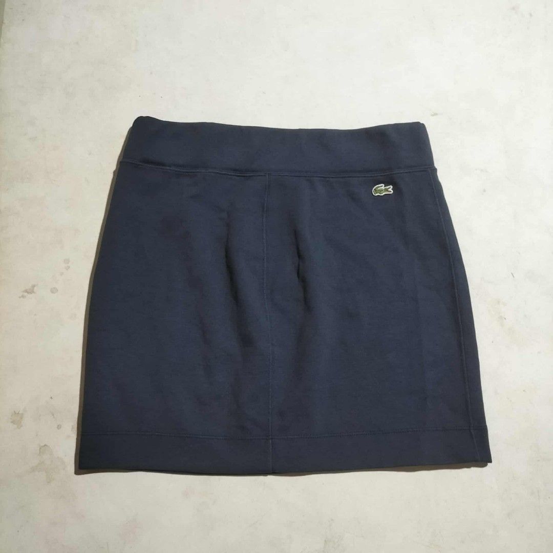 Lacoste Navy Blue Skirt Size 34 (Category: Skirts) located in Sindangan. Submitted by mix_thrift0308 (Listing ID 1425537073, Image 2). Description: Navy blue skirt from Lacoste. Features the iconic Lacoste logo on the front. The size tag indicates a size 34. Perfect for casual wear or light activities. The skirt has a simple, classic design..