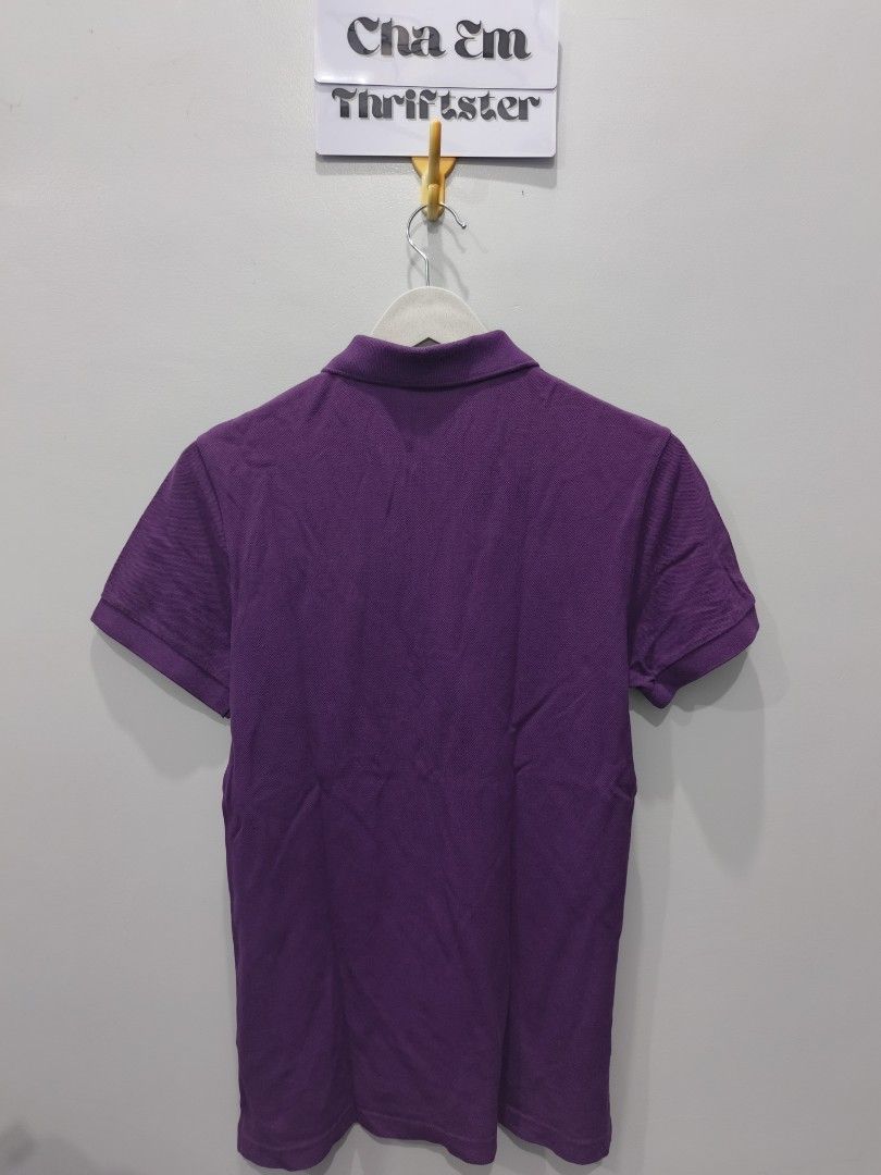 Lacoste Purple Polo Shirt (Category: Tshirts & Polo Shirts ) located in Leyte. Submitted by chaem89 (Listing ID 1425590457, Image 2). Description: Authentic Lacoste polo shirt in a vibrant purple color. Features the iconic Lacoste logo on the chest. The shirt has a classic polo collar and short sleeves. Size 4. Made from 100% cotton. Perfect for casual wear. -Very Good Cond - Issue: slight fade neck fold (refer to last photo) -sz 4 on tag 18x26.
