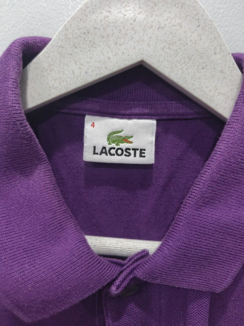 Lacoste Purple Polo Shirt (Category: Tshirts & Polo Shirts ) located in Leyte. Submitted by chaem89 (Listing ID 1425590457, Image 3). Description: Authentic Lacoste polo shirt in a vibrant purple color. Features the iconic Lacoste logo on the chest. The shirt has a classic polo collar and short sleeves. Size 4. Made from 100% cotton. Perfect for casual wear. -Very Good Cond - Issue: slight fade neck fold (refer to last photo) -sz 4 on tag 18x26.