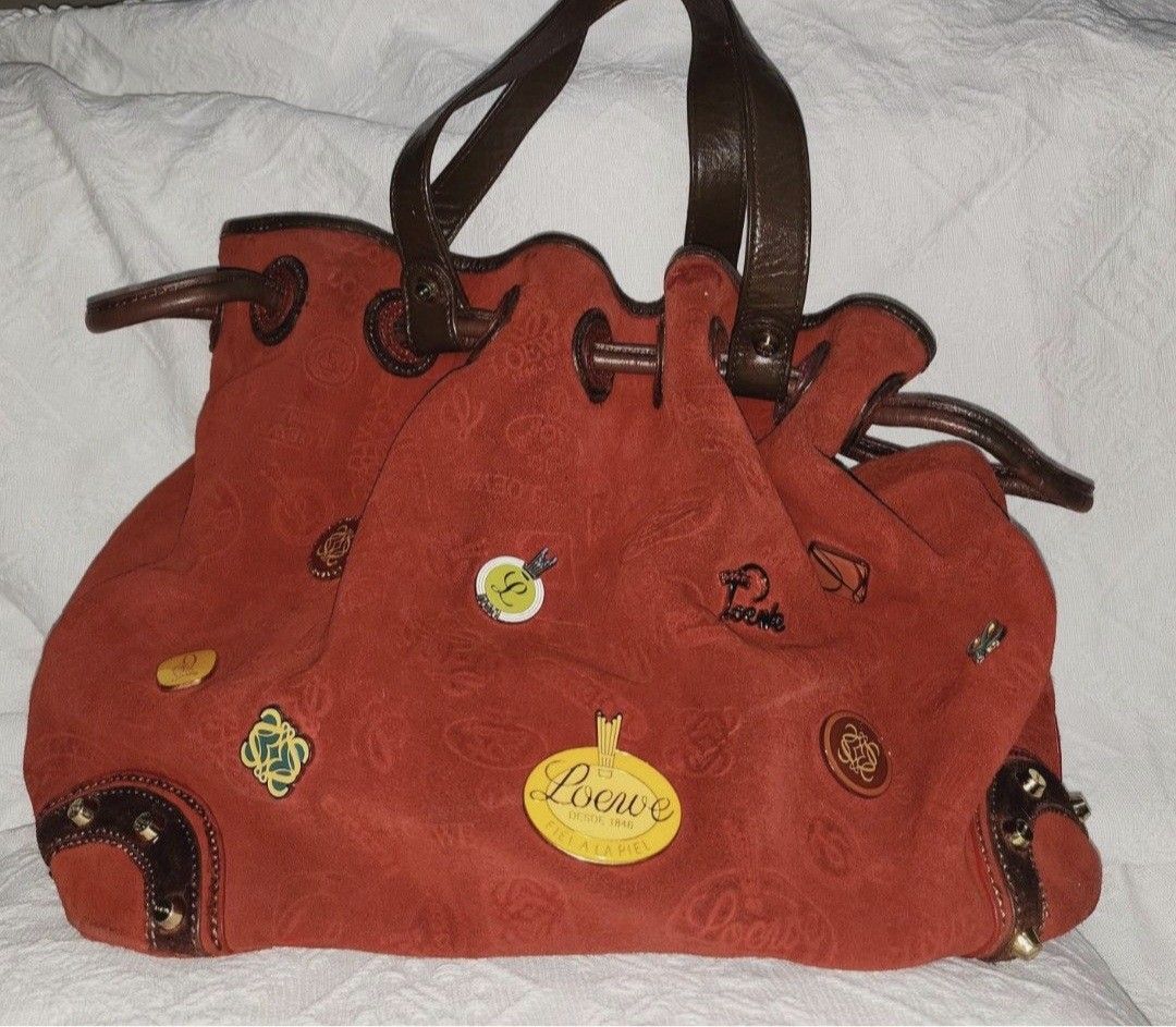 Loewe ( anniversary ed) (Category: Luxury Bags & Wallets) located in Manila. Submitted by givesudlyt08 (Listing ID 1425520996, Image 2). Description: - Loewe Anniversary Edition Shoulder Bag - Eye-catching red color - Crafted from a soft, suede-like material - Features leather handles and trim - Adorned with decorative pins - A stylish and unique bag.