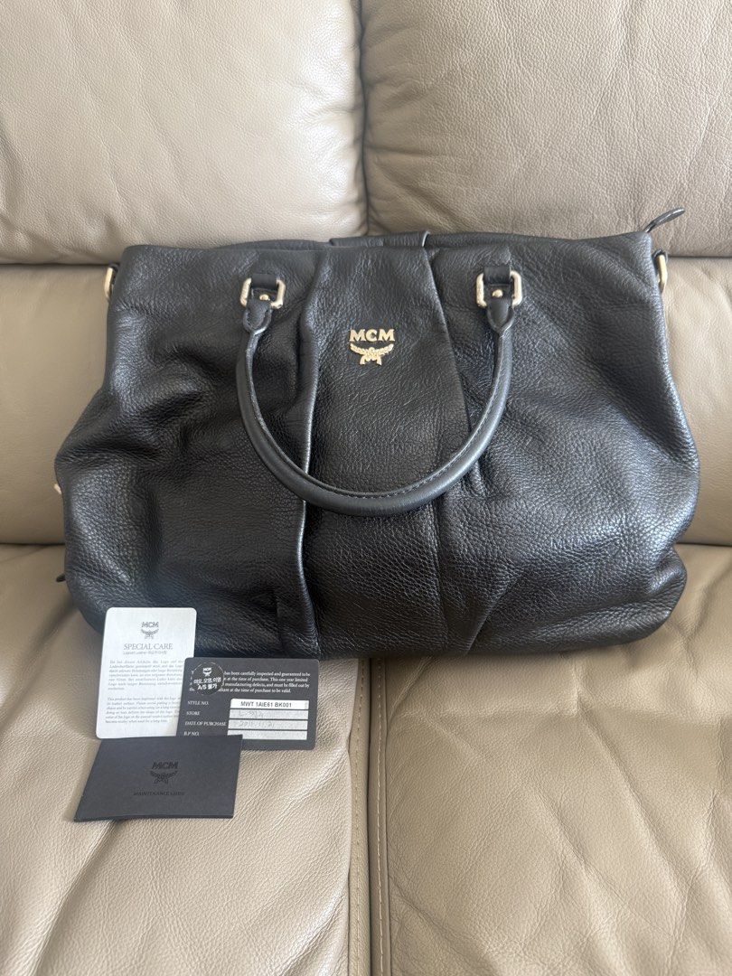 MCM Black Leather Handbag (Category: Luxury Bags & Wallets) located in Makati City. Submitted by markussangabriel (Listing ID 1425450929, Image 1). Description: Black leather handbag from MCM. Features a top handle and a shoulder strap. Includes MCM authenticity cards. The bag has gold-tone hardware and the MCM logo is visible on the front. The interior has a metal MCM tag with the serial number Z4914. Lost strap. .