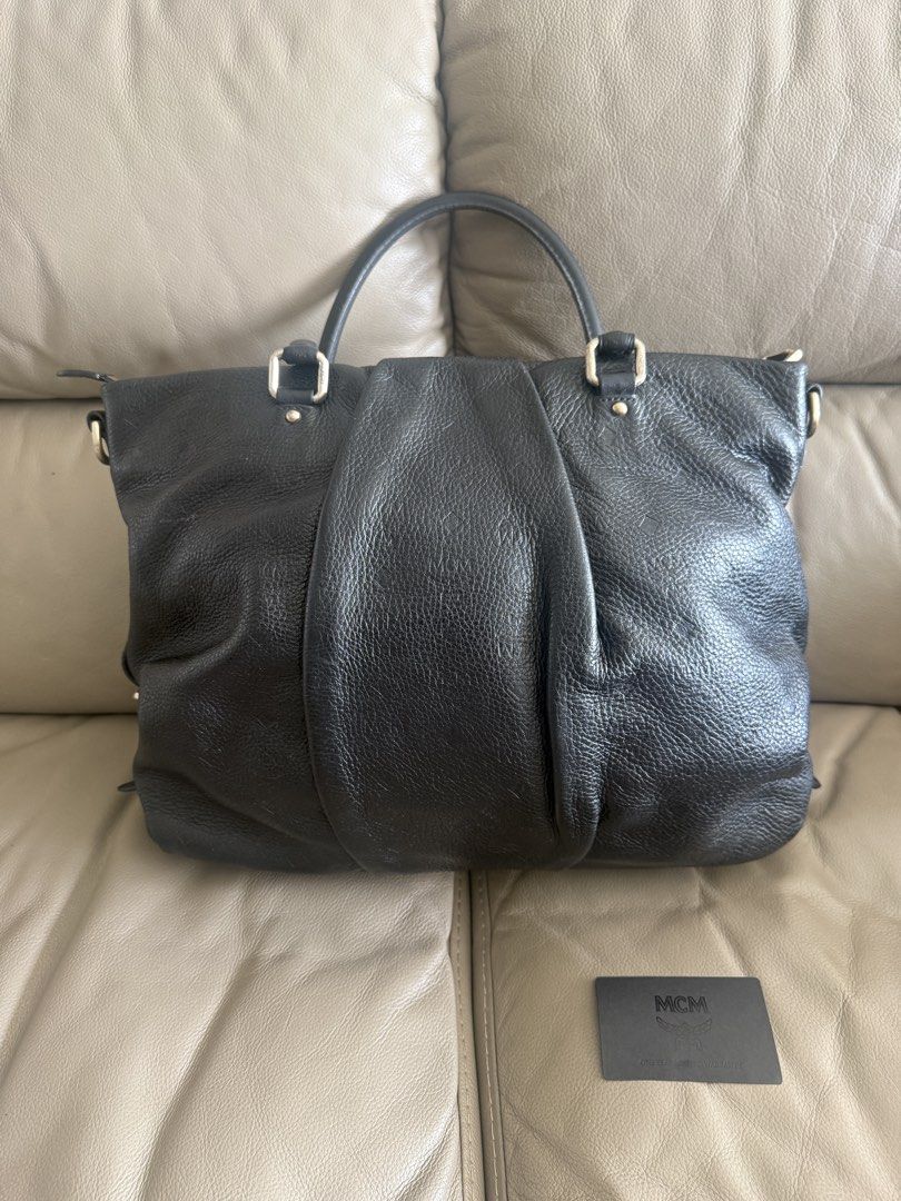 MCM Black Leather Handbag (Category: Luxury Bags & Wallets) located in Makati City. Submitted by markussangabriel (Listing ID 1425450929, Image 3). Description: Black leather handbag from MCM. Features a top handle and a shoulder strap. Includes MCM authenticity cards. The bag has gold-tone hardware and the MCM logo is visible on the front. The interior has a metal MCM tag with the serial number Z4914. Lost strap. .