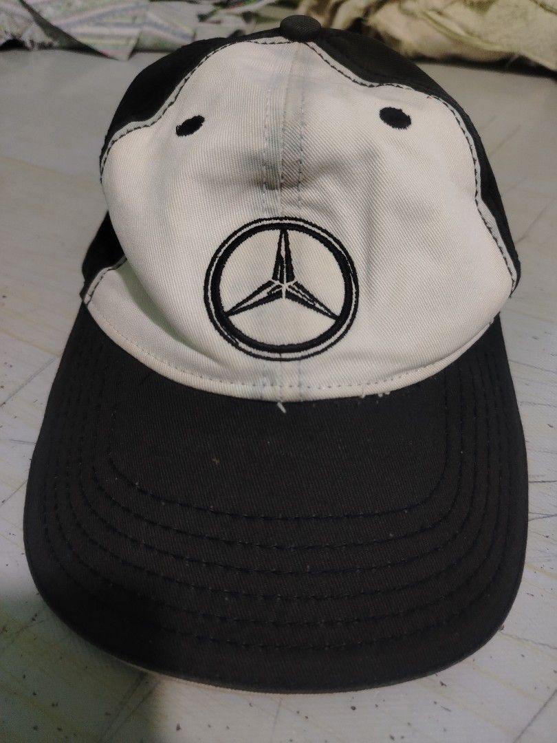 Mercedes-Benz Cap (Category: Caps & Hats) located in Quezon City. Submitted by secondlifestyleph (Listing ID 1425616011, Image 1). Description: Cap features the iconic Mercedes-Benz logo on the front. It has a black brim and a white front panel. It has a classic baseball cap design, suitable for everyday wear. The cap is a stylish accessory for any Mercedes-Benz enthusiast..