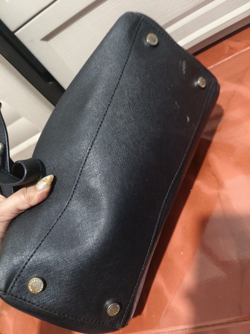 Michael Kors Black Bag Ciara Siffiano (Category: Luxury Bags & Wallets) located in Manila. Submitted by teacherkei (Listing ID 1425595539, Image 3). Description: Black Michael Kors satchel bag with silver-tone hardware. Features a top handle and a detachable shoulder strap. The interior has a zip pocket and is lined with the Michael Kors logo. The bag has a zip closure and metal feet on the bottom. The exterior shows some signs of wear. Padala fr