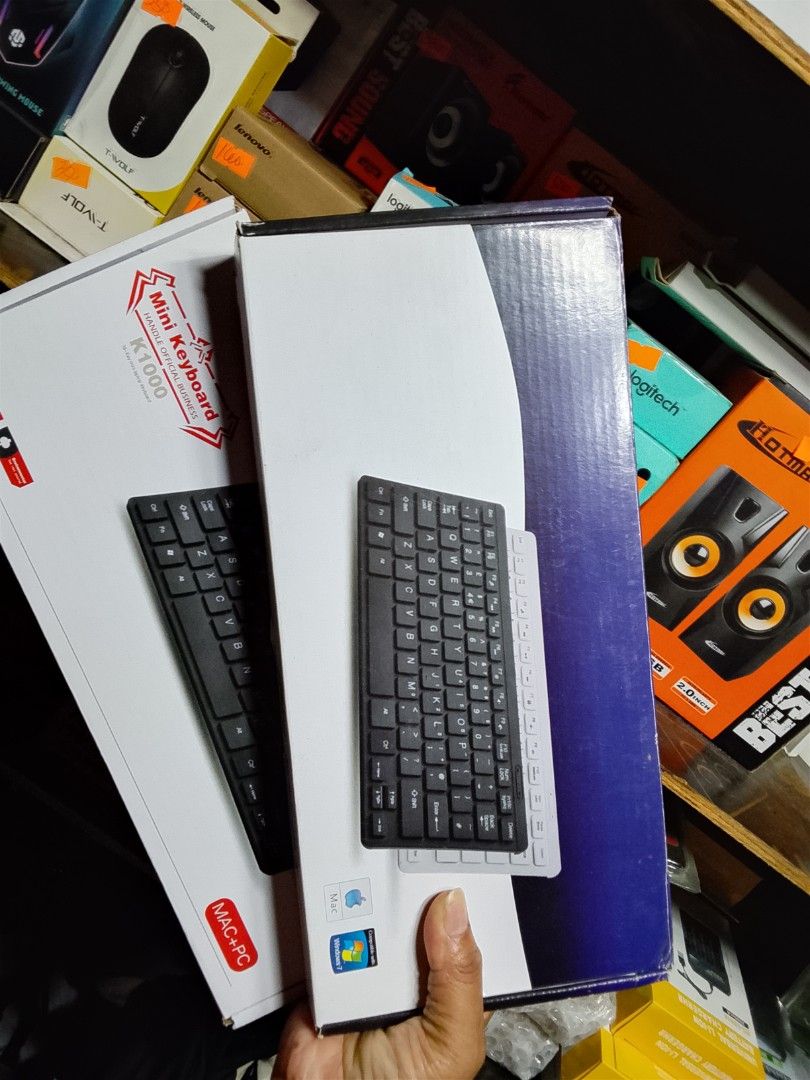 Mini Keyboard K1060 (Category: Computer Keyboard) located in Cebu City. Submitted by gracemarvin06 (Listing ID 1425541155, Image 1). Description: Mini keyboard, model K1060. It is black and comes in its original packaging. The keyboard is wired. It is designed for MAC and PC. The box shows the keyboard's design. The keyboard is still in its original plastic wrapping..