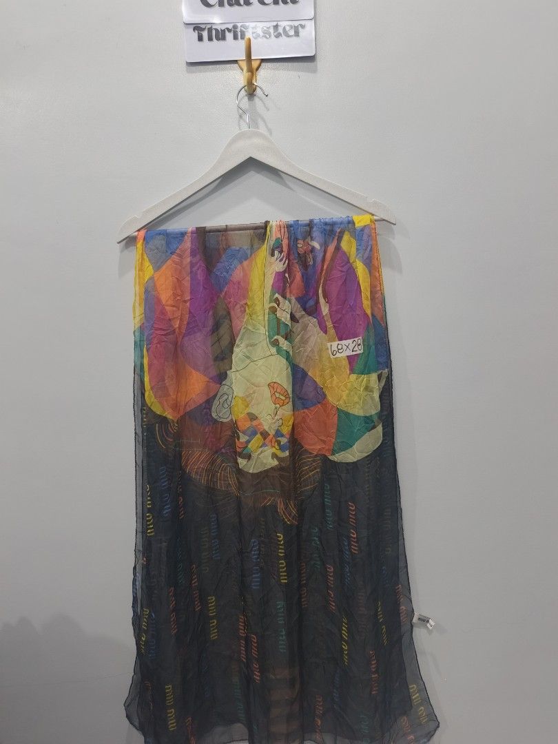Miu Miu Harlequin Silk Scarf (Category: Luxury Accessories) located in Leyte. Submitted by chaem89 (Listing ID 1425599222, Image 1). Description: Limited Edition Miu Miu Harlequin silk scarf. Features a colorful geometric and artistic design. The scarf is made in Italy and is 100% silk. The scarf has the Miu Miu logo printed on it. The dimensions are approximately 68x28 inches. .