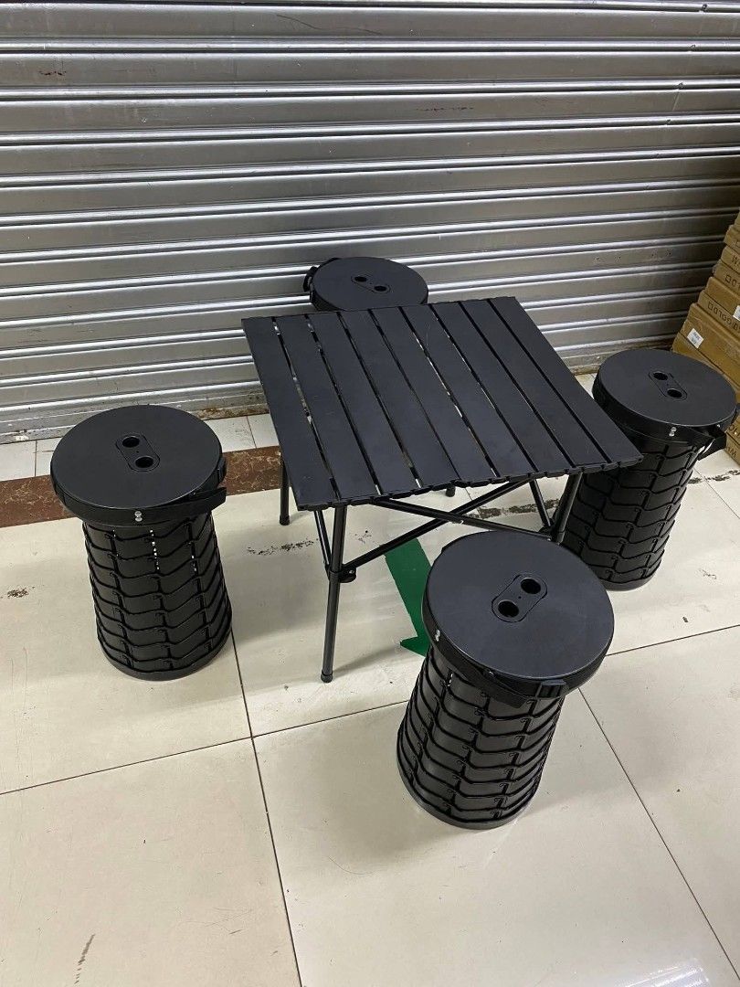 Portable Folding Table and Stools Set (Category: Tables & Sets) located in Manila. Submitted by lyfrancois14 (Listing ID 1425545984, Image 1). Description: Set includes a folding table and four matching stools. The table has a slatted top and a foldable frame. The stools are cylindrical and also appear to be foldable. All items are black. This set is ideal for outdoor activities, camping, or small spaces..