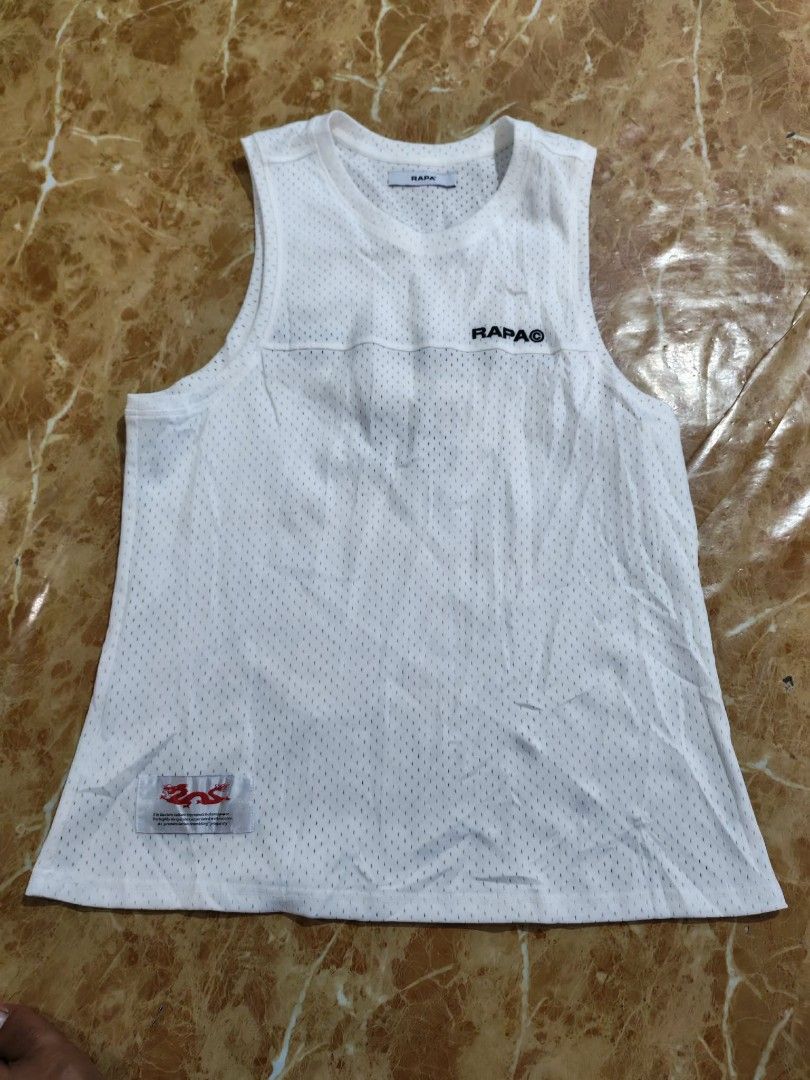 Rapa Studio White Tank Top (Category: Vests) located in Sipalay. Submitted by boldowl.e4f283 (Listing ID 1425448261, Image 1). Description: White tank top from Rapa Studio. Features the brand name on the front and back, along with the number "58" on the back. The tank top has a mesh-like texture. It has a size L label. The care label indicates it can be machine washed and ironed..
