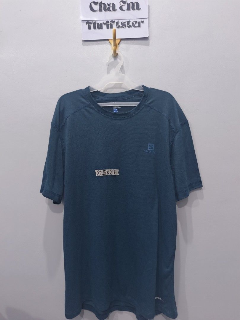 Salomon Active T-Shirt - Teal (Category: Activewear) located in Leyte. Submitted by chaem89 (Listing ID 1425578290, Image 1). Description: Salomon Active T-Shirt in teal. Features the Salomon logo on the chest. Made in Thailand. Designed for freedom. The shirt has a simple design with a crew neck and short sleeves. The back of the shirt has a reflective strip. Made of a lightweight material. Like new Cond sz M on tag 21.5x27.