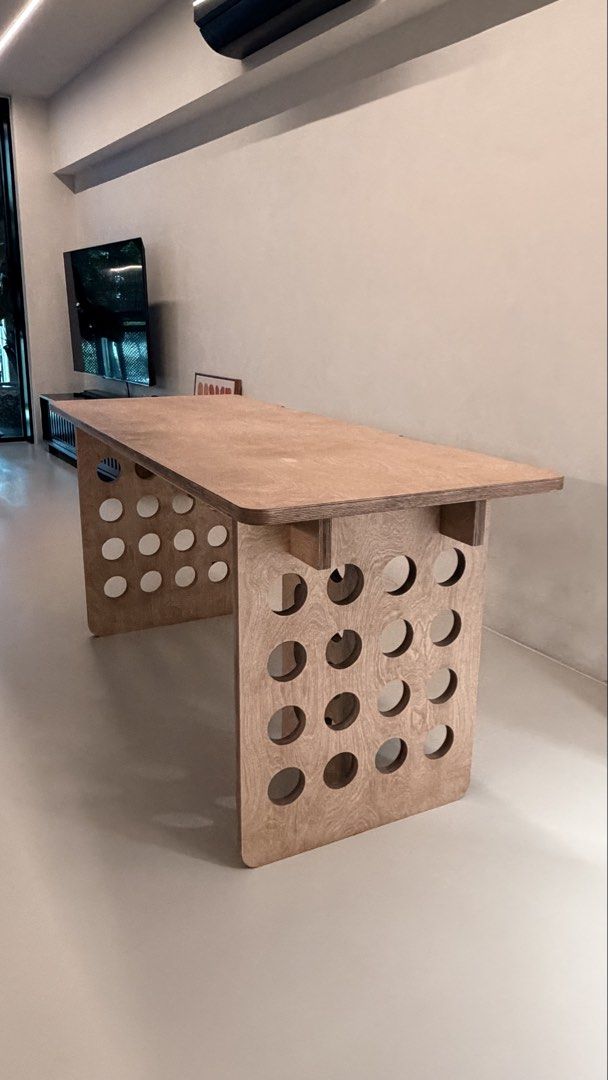 Solid birch - Study / Computer desk (Category: Tables & Sets) located in Singapore. Submitted by onetodee (Listing ID 1425539504, Image 2). Description: Measurements: 1600 L x 650 W x 75 H. Table has been dismantled for easy delivery. Screws all intact. Nice quality finish. Delivery at your own cost. Cheers! Stylish wooden desk with a unique design featuring circular cutouts on the legs. Perfect for a home office or study space. The desk offers a