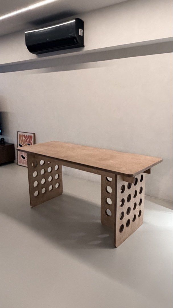 Solid birch - Study / Computer desk (Category: Tables & Sets) located in Singapore. Submitted by onetodee (Listing ID 1425539504, Image 1). Description: Measurements: 1600 L x 650 W x 75 H. Table has been dismantled for easy delivery. Screws all intact. Nice quality finish. Delivery at your own cost. Cheers! Stylish wooden desk with a unique design featuring circular cutouts on the legs. Perfect for a home office or study space. The desk offers a